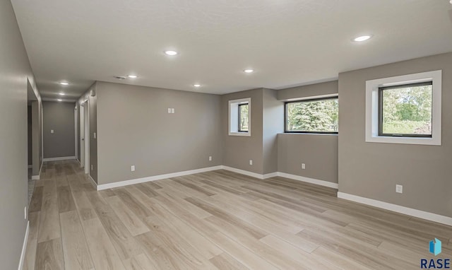 unfurnished room with light hardwood / wood-style floors