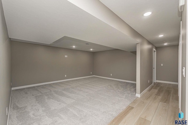 basement with light hardwood / wood-style floors