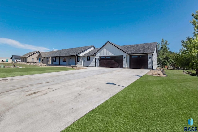 view of front of house featuring a garage and a front lawn