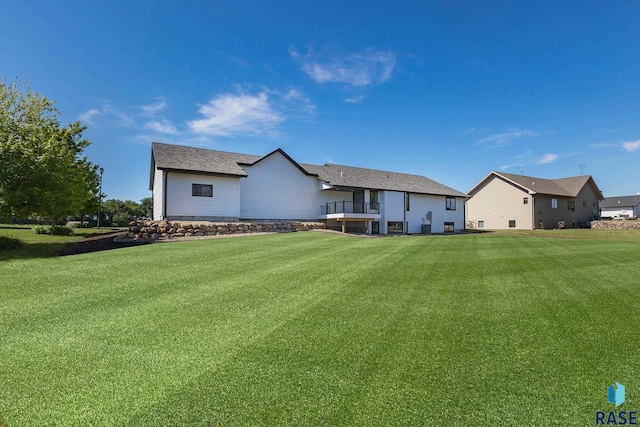 rear view of property with a lawn