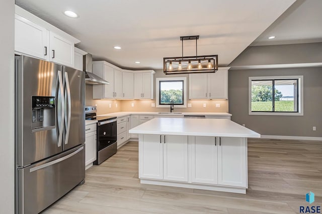 kitchen with white cabinetry, decorative light fixtures, a center island, and appliances with stainless steel finishes