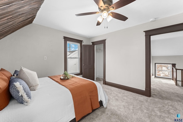 carpeted bedroom featuring multiple windows, lofted ceiling, and ceiling fan