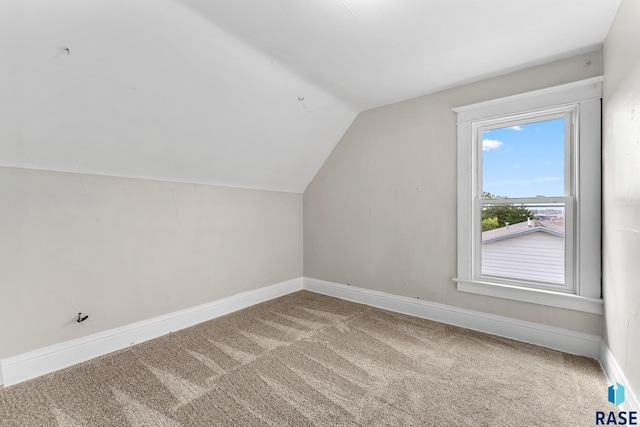 bonus room with vaulted ceiling and carpet