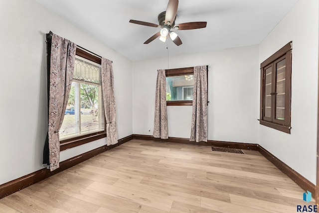 unfurnished room with ceiling fan and light hardwood / wood-style floors