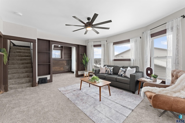 living room featuring light colored carpet and ceiling fan