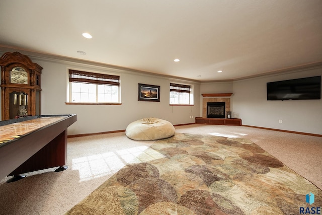 interior space with ornamental molding, a fireplace, and light colored carpet