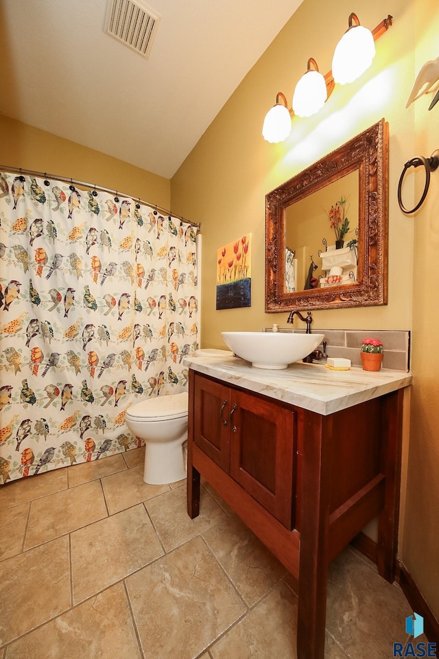 bathroom with vanity, tile patterned flooring, and toilet