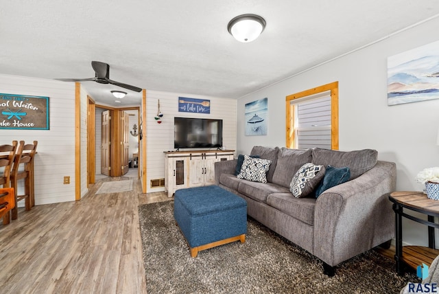 living room featuring hardwood / wood-style flooring and ceiling fan