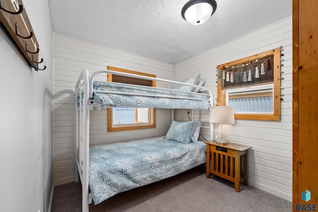 carpeted bedroom featuring a textured ceiling