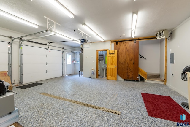 garage featuring a garage door opener and electric panel