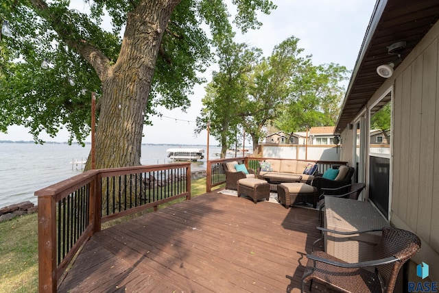 deck with an outdoor hangout area and a water view