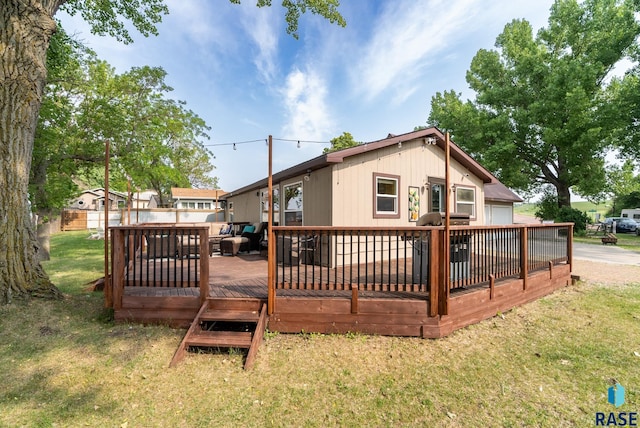 back of house with a wooden deck and a yard