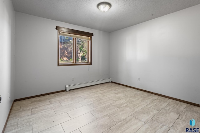 empty room featuring a textured ceiling and a baseboard heating unit