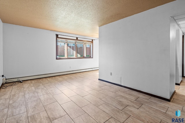 empty room featuring a baseboard radiator and a textured ceiling