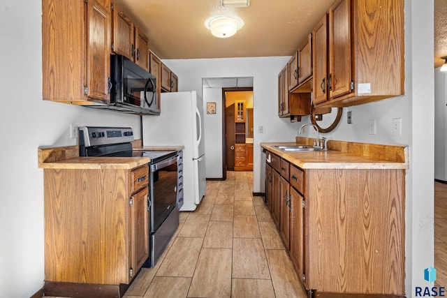 kitchen featuring electric stove and sink