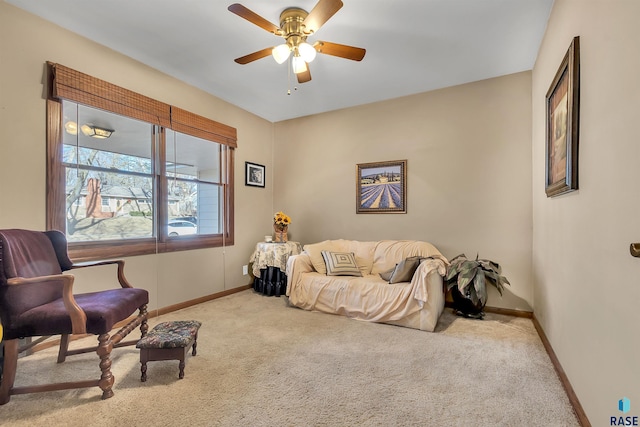 living area with ceiling fan and light colored carpet