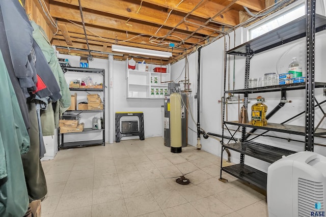 basement with plenty of natural light and electric water heater