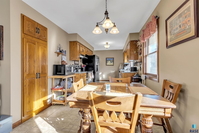 dining room with an inviting chandelier and light tile patterned floors