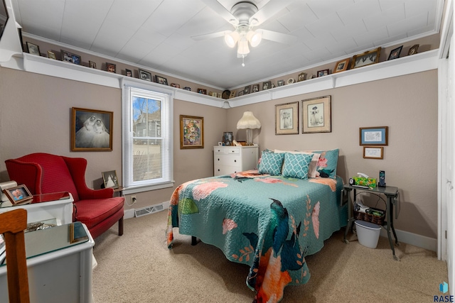 bedroom with ceiling fan, ornamental molding, and carpet flooring