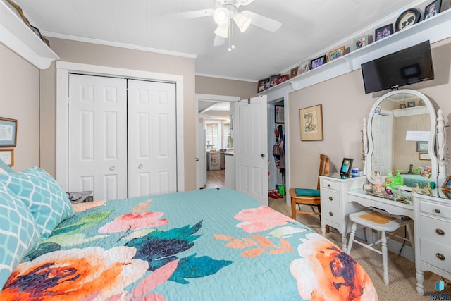 bedroom featuring ornamental molding, a closet, ceiling fan, and carpet