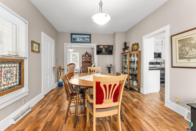 dining area with hardwood / wood-style flooring