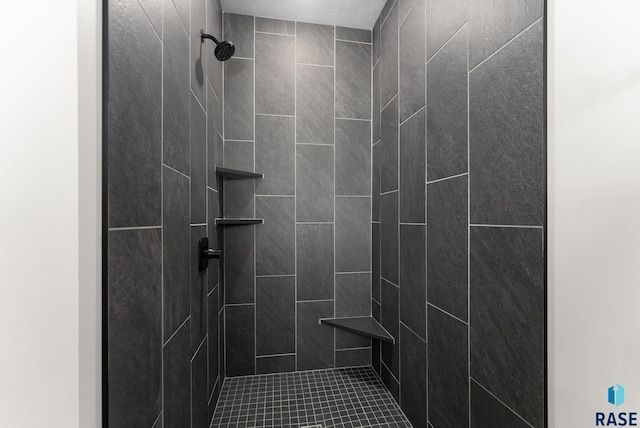 bathroom with a tile shower