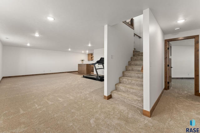 basement featuring light colored carpet