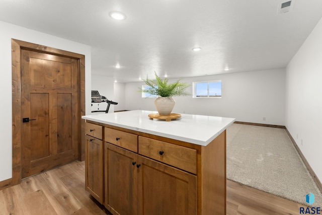 kitchen with a center island and light hardwood / wood-style flooring