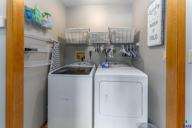 clothes washing area with separate washer and dryer