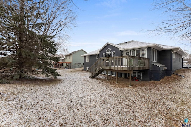 rear view of house featuring a wooden deck