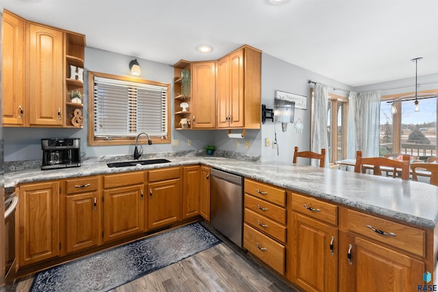 kitchen with sink, dark hardwood / wood-style floors, light stone counters, decorative light fixtures, and stainless steel dishwasher