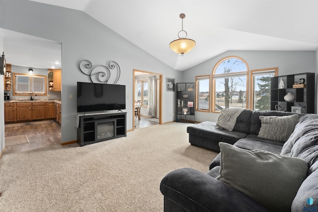 living room with sink, vaulted ceiling, and carpet