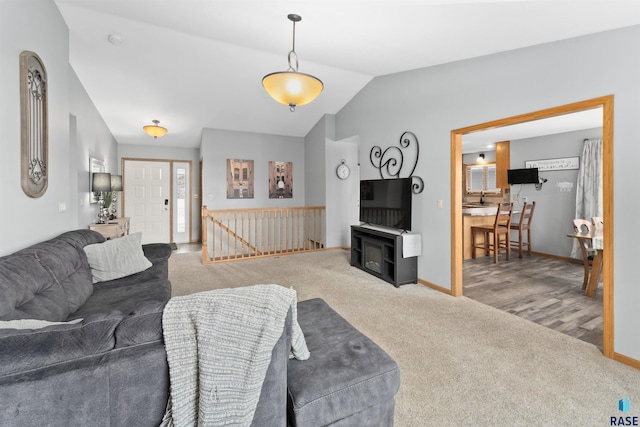 living room featuring lofted ceiling and carpet