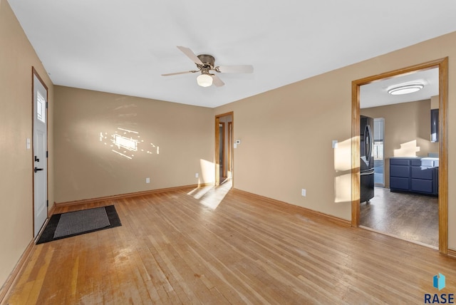 empty room with ceiling fan and light wood-type flooring