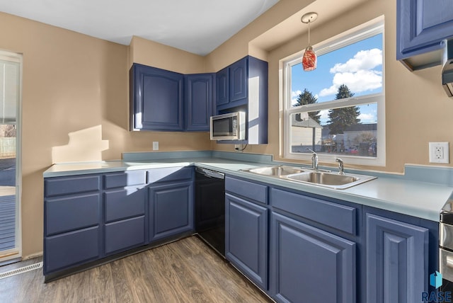 kitchen with blue cabinets, sink, dark hardwood / wood-style floors, black dishwasher, and pendant lighting