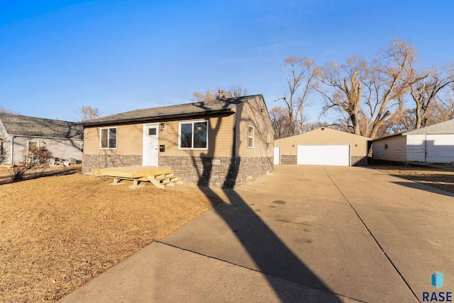 ranch-style house with a garage and an outbuilding