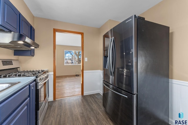 kitchen with stainless steel gas stove, black fridge with ice dispenser, dark hardwood / wood-style flooring, and blue cabinetry