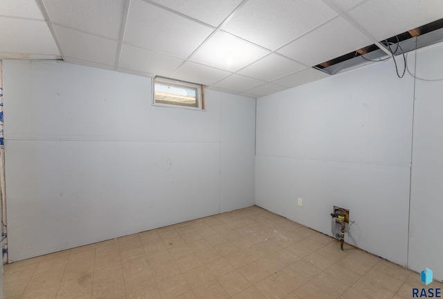 basement with a paneled ceiling