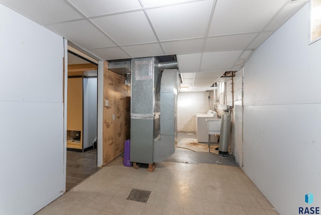 basement with heating unit and a drop ceiling