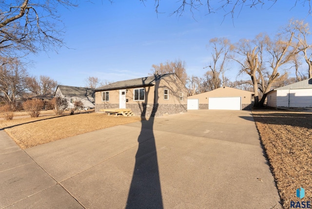 single story home with a garage and an outdoor structure