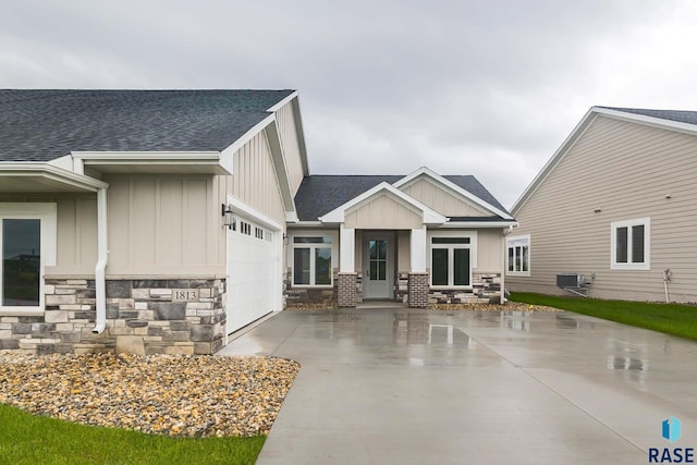 view of front of home featuring a garage and cooling unit