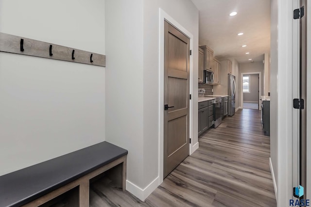 mudroom with light hardwood / wood-style floors