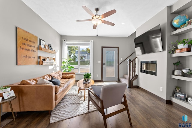 living room with ceiling fan and dark hardwood / wood-style flooring