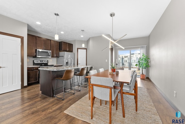 dining area with dark hardwood / wood-style floors