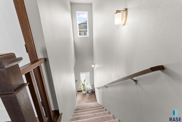 staircase featuring a towering ceiling