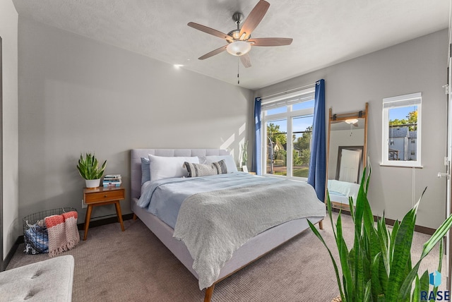 bedroom with a textured ceiling, ceiling fan, and carpet flooring