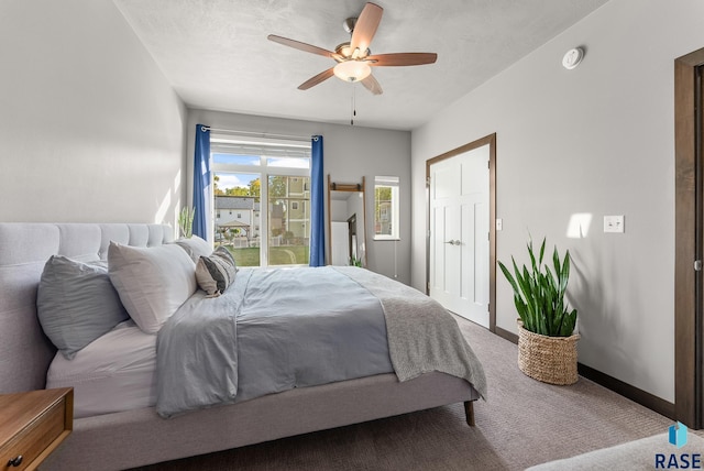 bedroom featuring ceiling fan and carpet