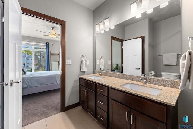 bathroom with vanity, ceiling fan, and toilet