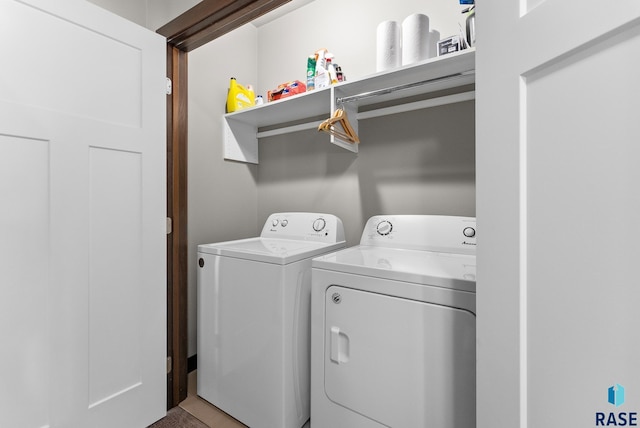 laundry area featuring washing machine and clothes dryer