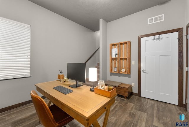 office area with a textured ceiling and dark hardwood / wood-style flooring